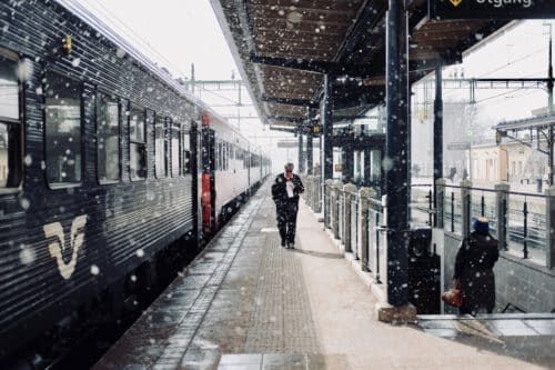 Train Driver Advisory System. Train conductor walking on the train platform in snow