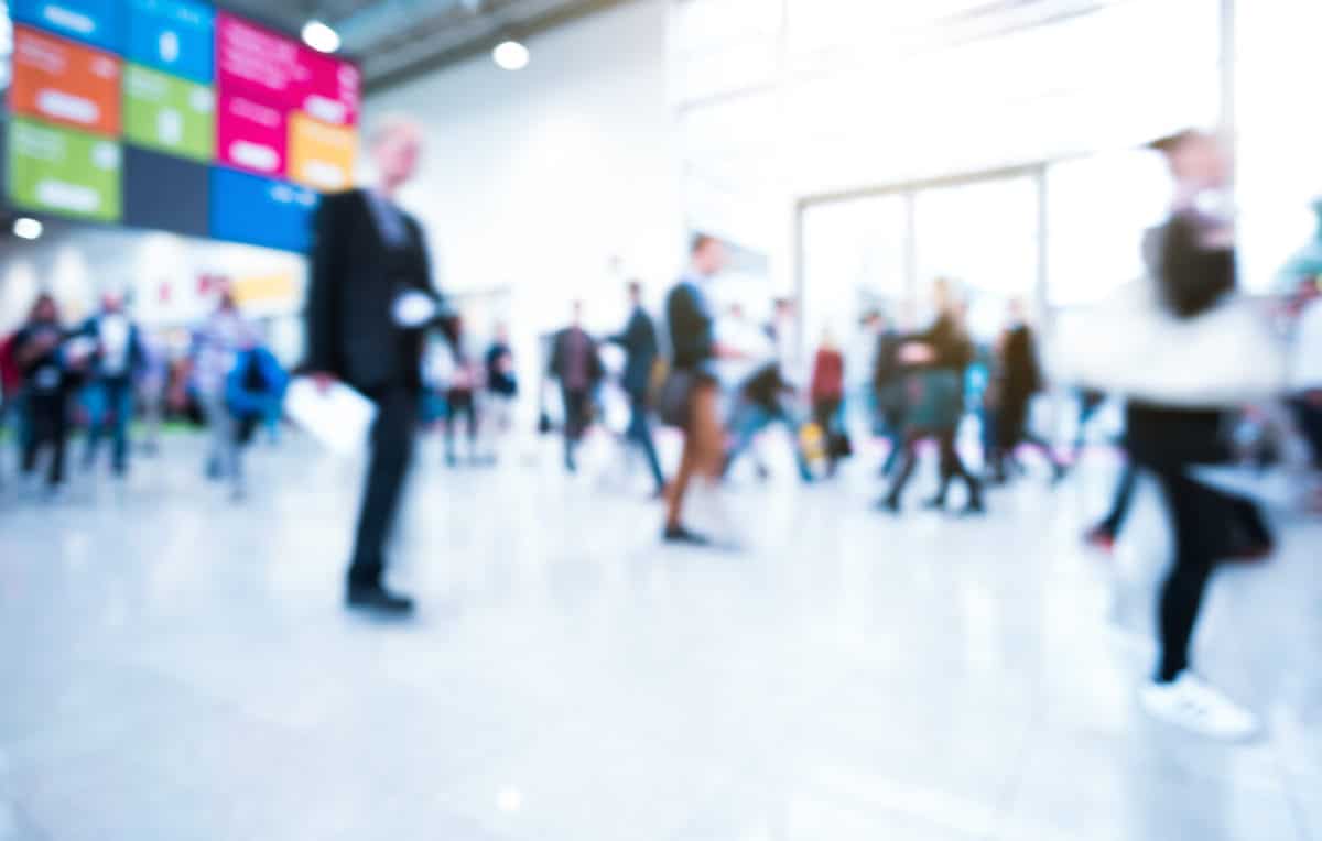 Blurred business people walking in a modern exhibition hall