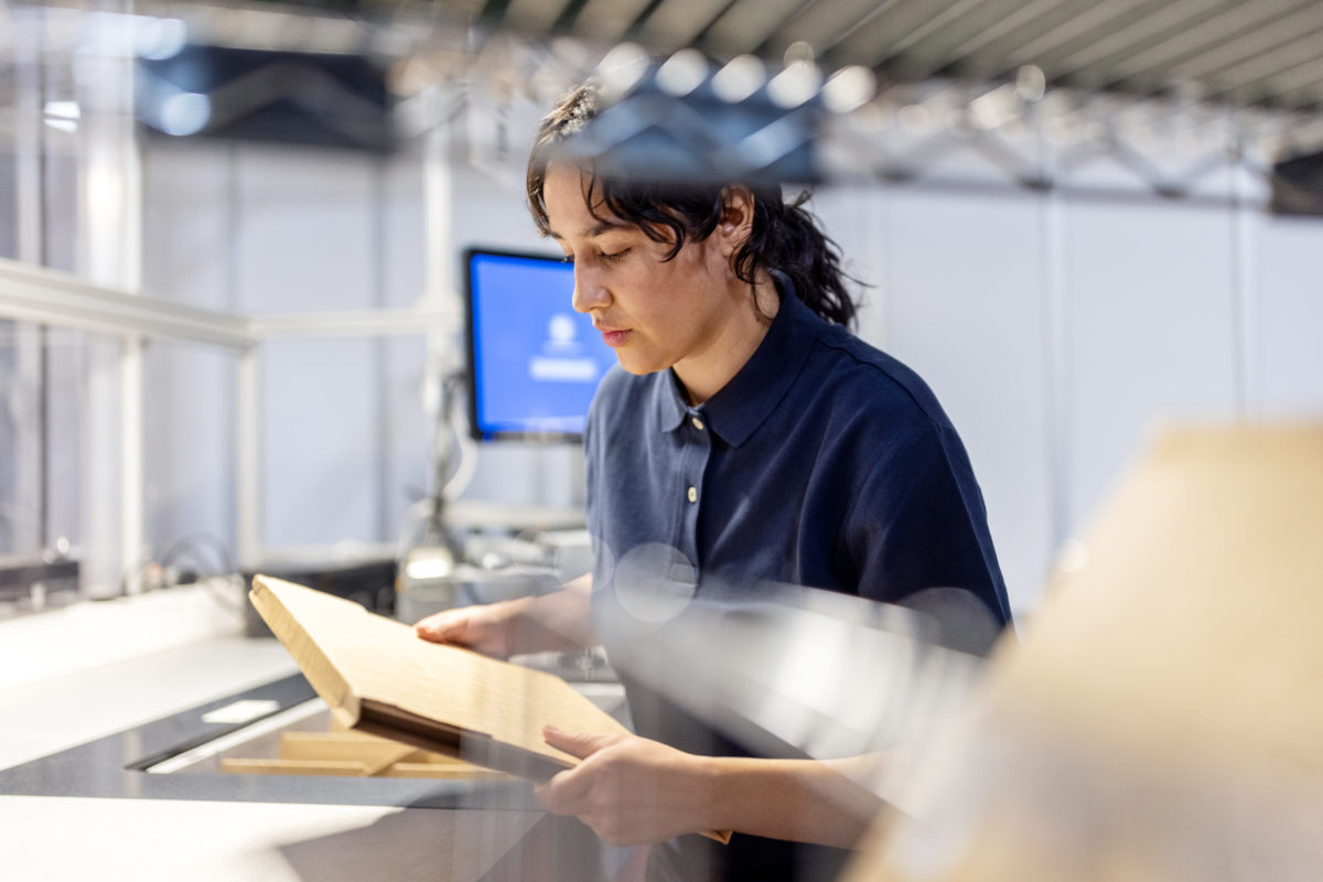 Woman in warehouse preparing a package for delivery